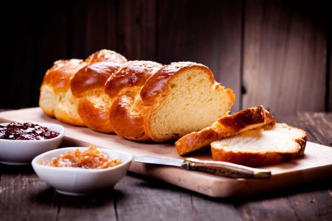 Brioche bread, cutting board, jams.